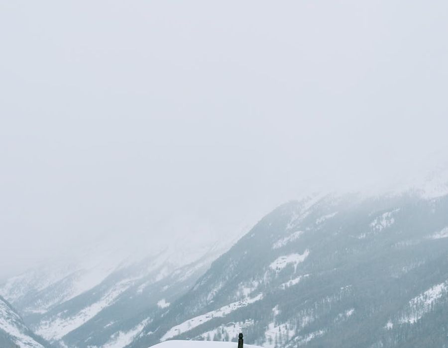 Cozy wooden mountain cabin surrounded by pristine winter snow