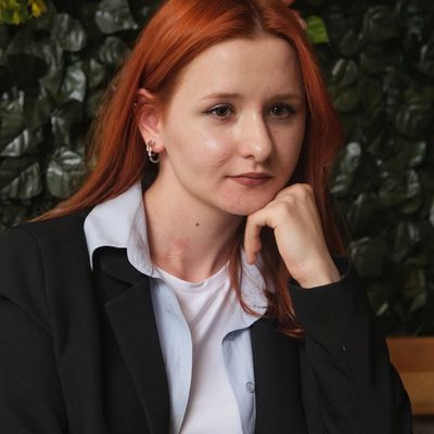 Friendly woman with light hair in elegant business attire