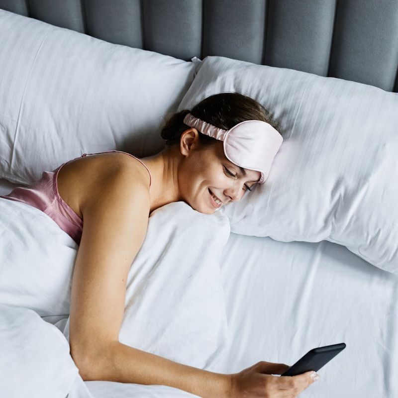 Happy travelers using mobile booking app in modern hotel lobby