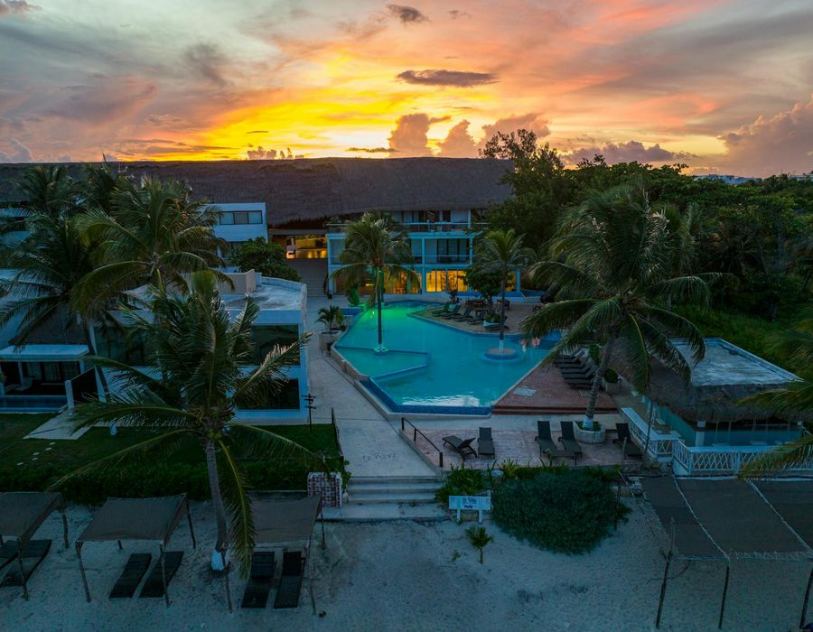 Luxury beachfront resort with stunning infinity pool at sunset