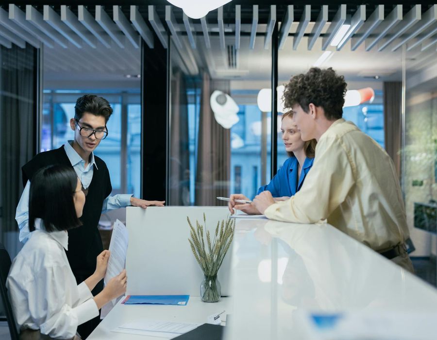 Professional team collaborating in modern office workspace environment